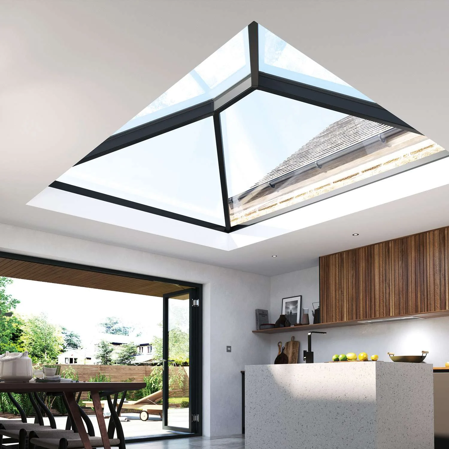 An external shot of a white flat roof extension showing a Korniche roof lantern installed on the roof, paired with a set of Korniche bi-folding doors that are slightly ajar.The fully furnished modern kitchen is visible through the bi-fold glass.