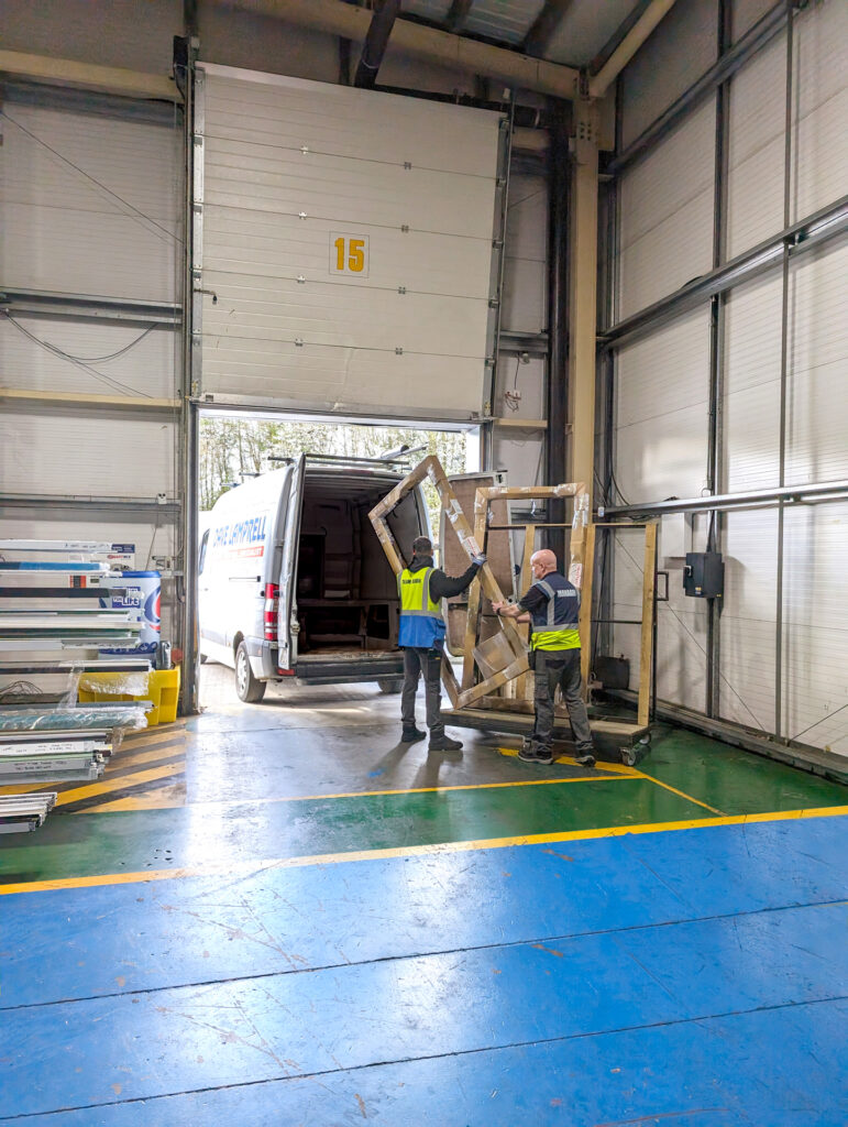 Made for Trade staff loading a bi-fold door into a van for Kwikcollect service.