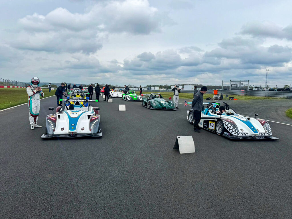 The drivers, Bradley Gaunt and Ashley Gaunt, are visible inside the cars preparing for the race.